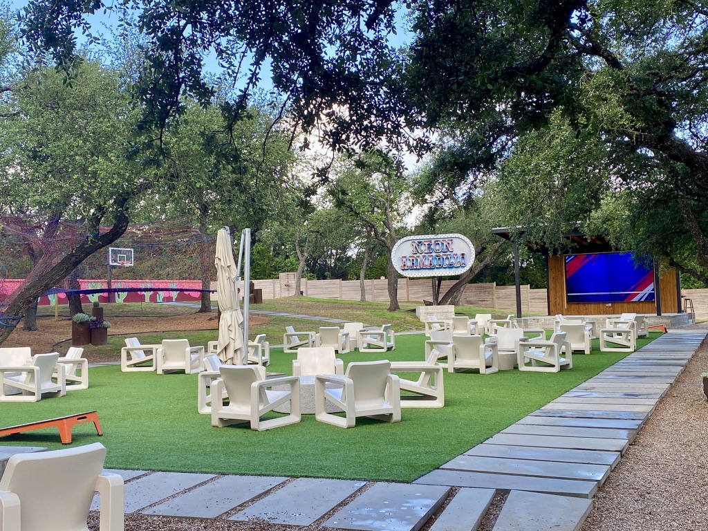 Outdoor area with kids play area at Neon Armadillo in Wimberley TX