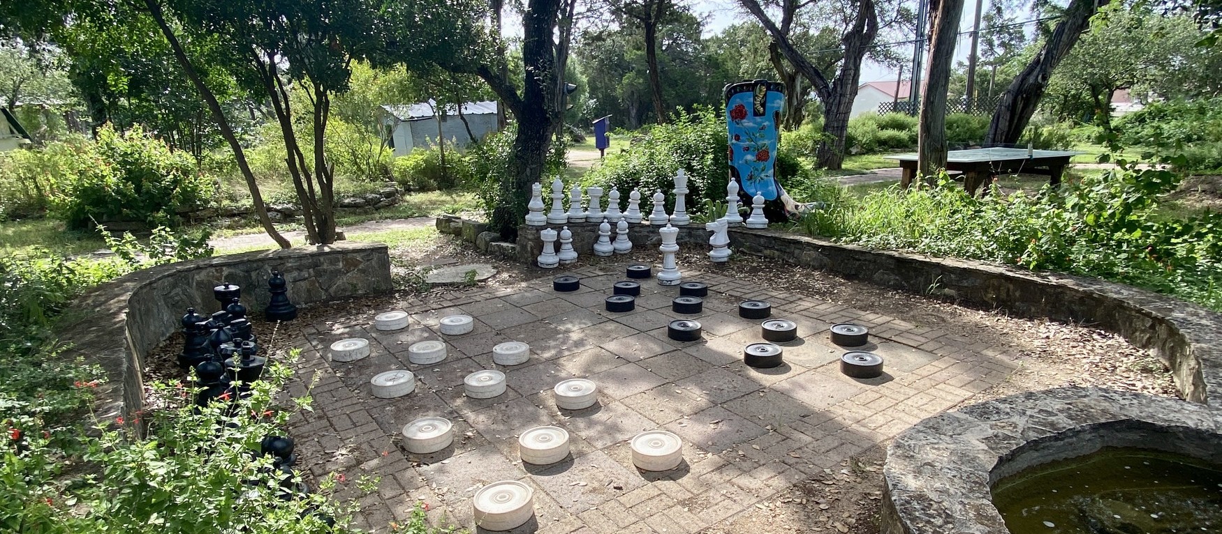 Giant chess and checkers in the gardens at EmilyAnn Theatre in Wimberley.